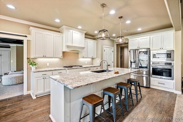 14610 N 144th E Ave, Collinsville, OK 74021 - kitchen featuring appliances with stainless steel finishes, wood tiled floors, recessed lighting, a kitchen bar, and decorative backsplash