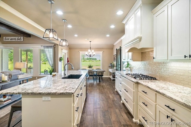 14610 N 144th E Ave, Collinsville, OK 74021 - kitchen with stainless steel gas stovetop, decorative backsplash, recessed lighting, a kitchen island with sink, and light stone counters