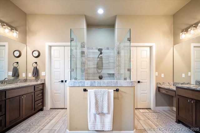 14610 N 144th E Ave, Collinsville, OK 74021 - full bath with tiled shower, two vanities, wood tiled floors, and recessed lighting