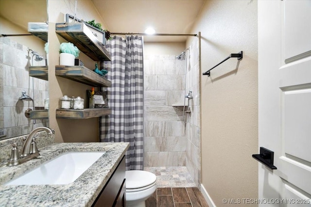 14610 N 144th E Ave, Collinsville, OK 74021 - bathroom featuring tiled shower, vanity, and wood finish floors