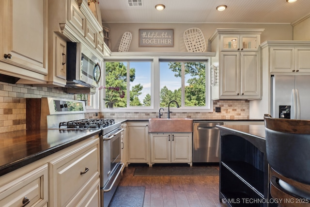 30150 S County Road 4430, Stigler, OK 74462 - kitchen featuring appliances with stainless steel finishes, dark countertops, decorative backsplash, dark wood-style flooring, and glass insert cabinets