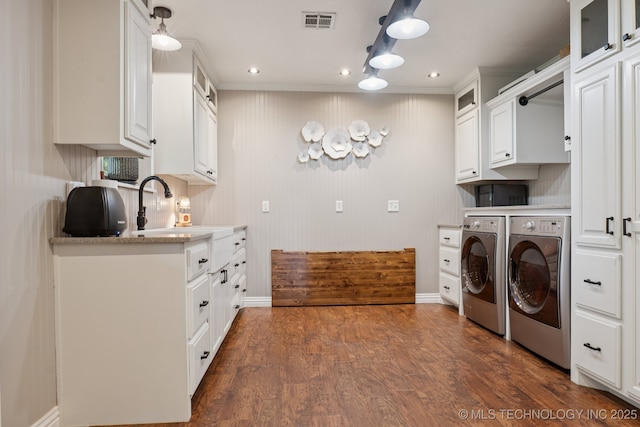 30150 S County Road 4430, Stigler, OK 74462 - laundry area featuring washer and dryer, dark wood-type flooring, recessed lighting, and ornamental molding