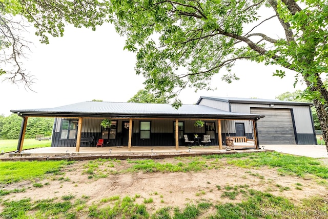 348550 E Parkside Dr, Pawnee, OK 74058 - rear view of house with a porch, driveway, and a metal roof