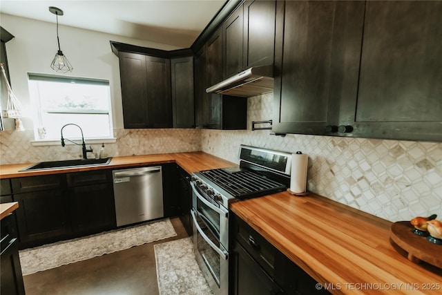 348550 E Parkside Dr, Pawnee, OK 74058 - kitchen featuring wood counters, stainless steel appliances, under cabinet range hood, tasteful backsplash, and pendant lighting