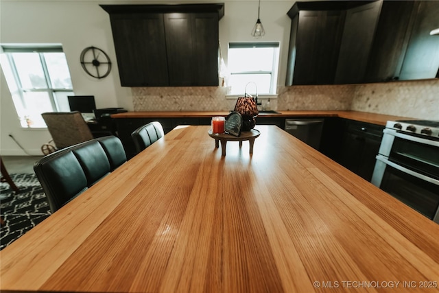 348550 E Parkside Dr, Pawnee, OK 74058 - kitchen featuring wood counters, range with two ovens, dishwasher, and healthy amount of natural light