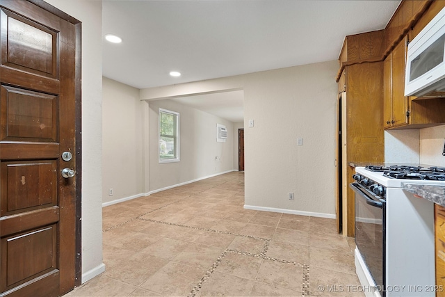 1624 7th NW, Ardmore, OK 73401 - kitchen with white appliances, recessed lighting, brown cabinetry, and light tile patterned flooring