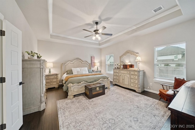 716 E 126th St, Jenks, OK 74037 - bedroom featuring a raised ceiling, dark wood-type flooring, and a ceiling fan