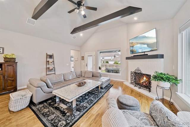 716 E 126th St, Jenks, OK 74037 - living area featuring wood finished floors, beam ceiling, a fireplace, a ceiling fan, and high vaulted ceiling