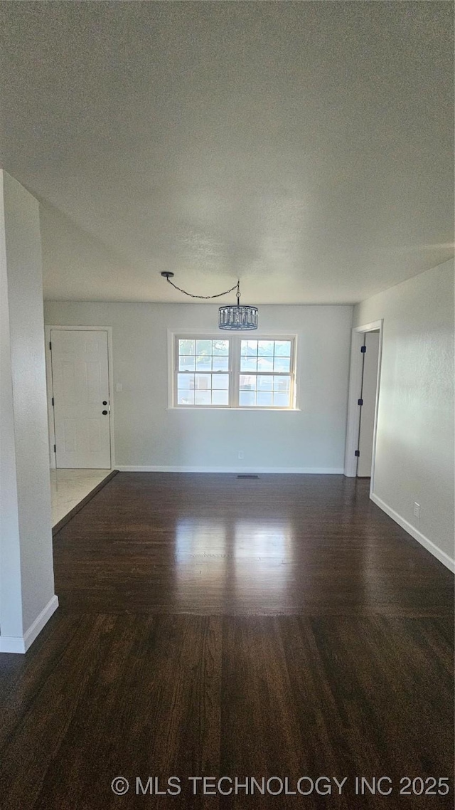 9705 E 5th St, Tulsa, OK 74128 - empty room with baseboards and wood finished floors