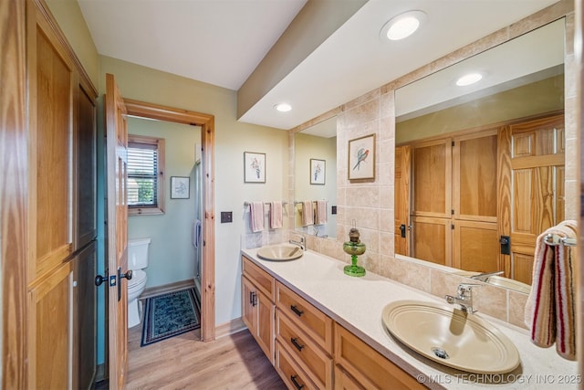 69125 E 252nd Rd, Wyandotte, OK 74370 - bathroom featuring double vanity, wood finished floors, and recessed lighting