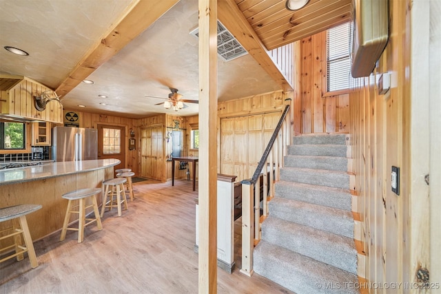 69125 E 252nd Rd, Wyandotte, OK 74370 - stairway with wooden walls, wood finished floors, ceiling fan, and recessed lighting