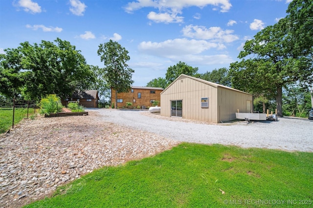 69125 E 252nd Rd, Wyandotte, OK 74370 - exterior space featuring a lawn and board and batten siding