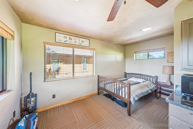 69125 E 252nd Rd, Wyandotte, OK 74370 - carpeted bedroom with ceiling fan and a wood stove