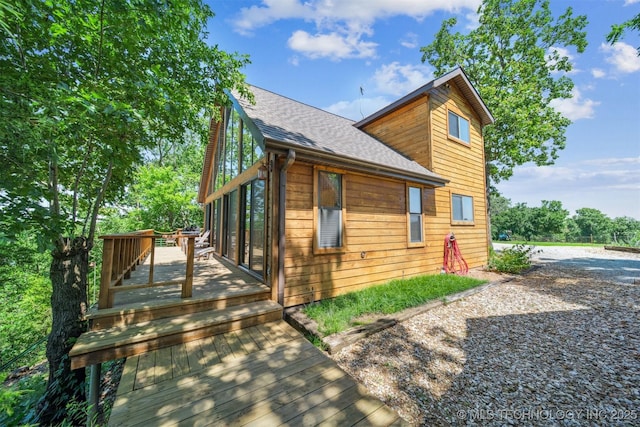 69125 E 252nd Rd, Wyandotte, OK 74370 - view of property exterior with a wooden deck and a shingled roof