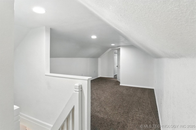 27719 S 610th Rd, Bunch, OK 74931 - additional living space featuring vaulted ceiling, dark carpet, a textured ceiling, and recessed lighting