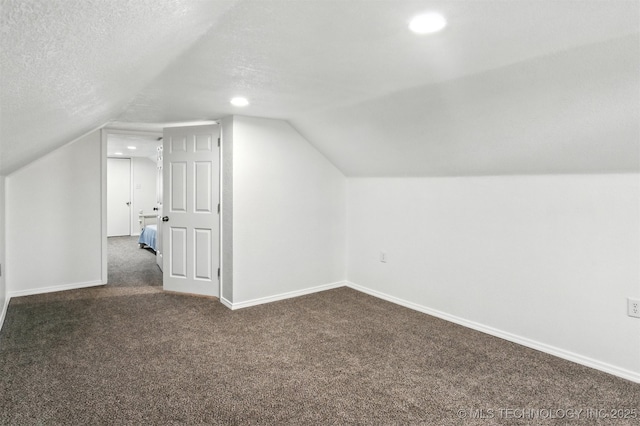 27719 S 610th Rd, Bunch, OK 74931 - additional living space with dark colored carpet, lofted ceiling, recessed lighting, and a textured ceiling