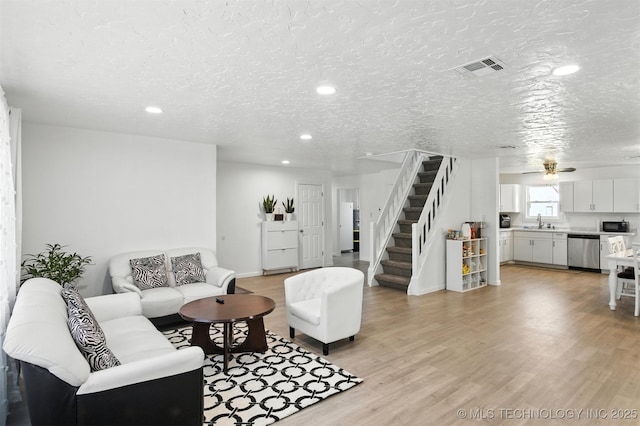 27719 S 610th Rd, Bunch, OK 74931 - living area featuring stairs, recessed lighting, light wood-type flooring, a textured ceiling, and a ceiling fan