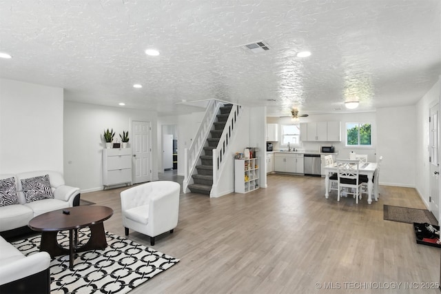 27719 S 610th Rd, Bunch, OK 74931 - living room with stairs, light wood-type flooring, a textured ceiling, recessed lighting, and a ceiling fan