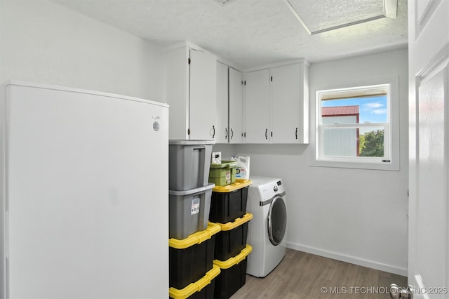 27719 S 610th Rd, Bunch, OK 74931 - laundry room featuring cabinet space, light wood-style flooring, a textured ceiling, and washer and clothes dryer