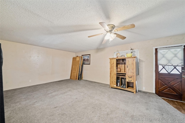 8817 E 2nd St, Tulsa, OK 74112 - carpeted empty room featuring a ceiling fan and a textured ceiling