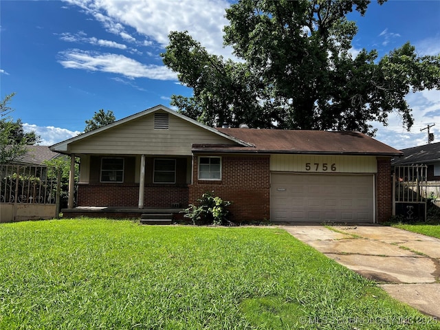 5756 E 28th St, Tulsa, OK 74114 - ranch-style home featuring an attached garage, brick siding, concrete driveway, and a front lawn