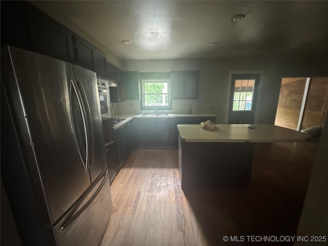 512 S Jules Ave, Cleveland, OK 74020 - kitchen featuring freestanding refrigerator, light wood-style flooring, black electric stovetop, light countertops, and recessed lighting