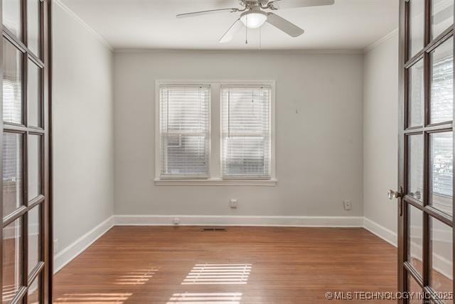 1531 S Florence Ave, Tulsa, OK 74104 - unfurnished room featuring crown molding, ceiling fan, wood finished floors, and french doors