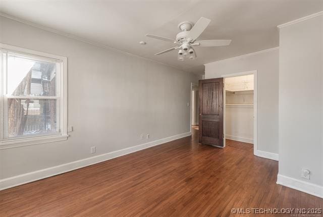 1531 S Florence Ave, Tulsa, OK 74104 - unfurnished bedroom with crown molding, wood finished floors, a walk in closet, a closet, and a ceiling fan