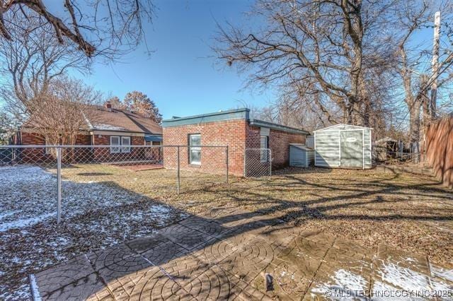 1531 S Florence Ave, Tulsa, OK 74104 - view of side of property featuring a shed, a fenced backyard, and brick siding