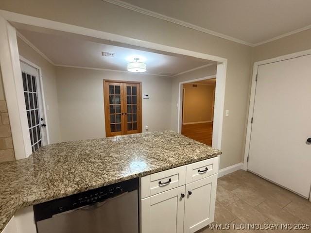 5321 S Owasso Ave, Tulsa, OK 74105 - kitchen with dishwasher, white cabinetry, light stone countertops, crown molding, and french doors