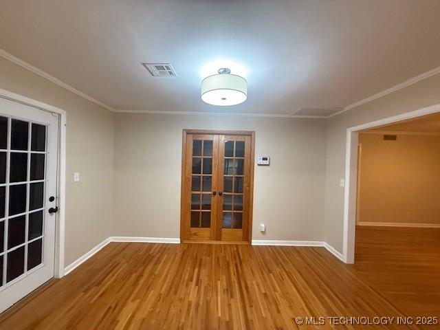 5321 S Owasso Ave, Tulsa, OK 74105 - unfurnished room featuring french doors, wood finished floors, and ornamental molding