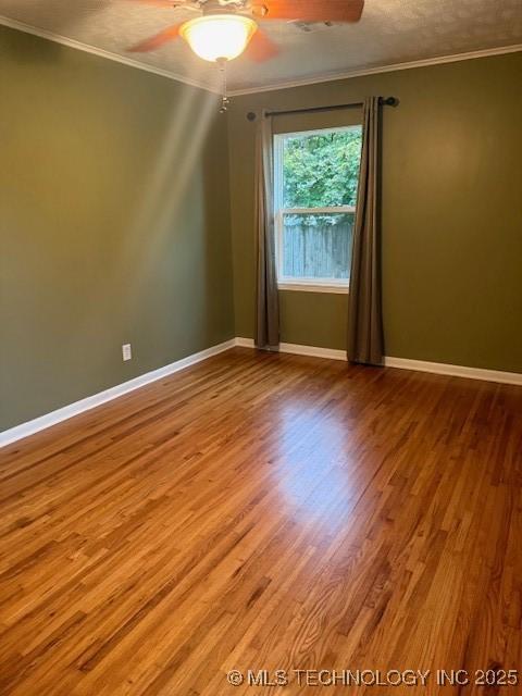 5321 S Owasso Ave, Tulsa, OK 74105 - unfurnished room with a ceiling fan, wood finished floors, and ornamental molding