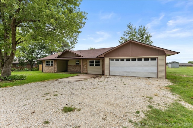 14400 County Road 3490, Ada, OK 74820 - single story home featuring a garage, gravel driveway, a front lawn, and brick siding