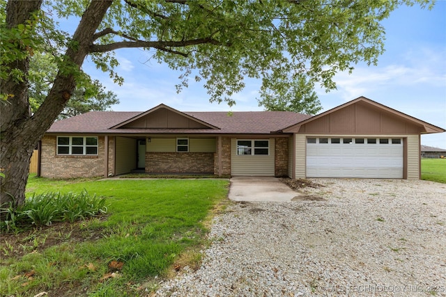 14400 County Road 3490, Ada, OK 74820 - view of front facade with driveway, a garage, board and batten siding, and a front yard