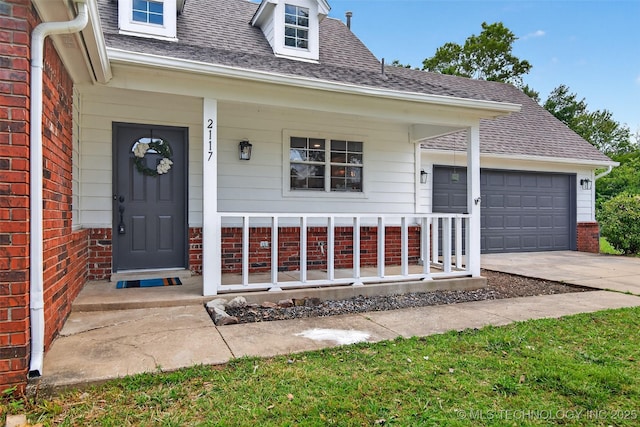 2117 Western Dr, Skiatook, OK 74070 - doorway to property with a porch, brick siding, concrete driveway, and roof with shingles