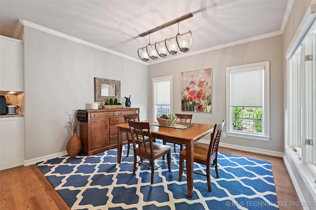 9319 S Indianapolis Ave, Tulsa, OK 74137 - dining area with light wood finished floors, a chandelier, plenty of natural light, and crown molding