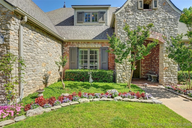 9319 S Indianapolis Ave, Tulsa, OK 74137 - property entrance featuring stone siding, a shingled roof, and a yard