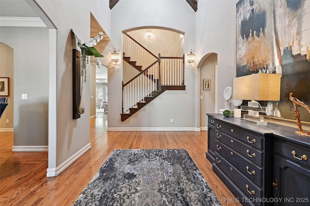 9319 S Indianapolis Ave, Tulsa, OK 74137 - entrance foyer featuring stairway, arched walkways, wood finished floors, and ornamental molding
