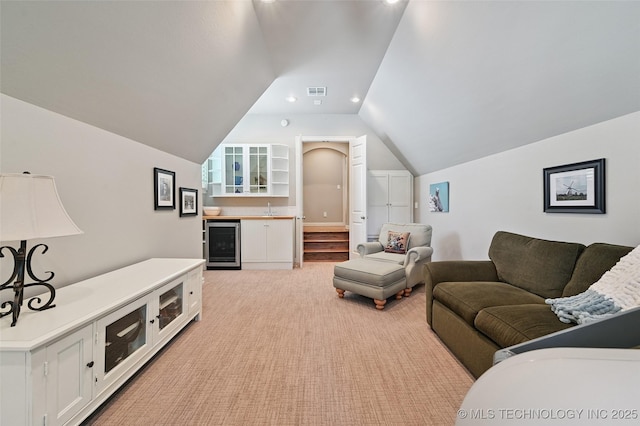 9319 S Indianapolis Ave, Tulsa, OK 74137 - living room with wine cooler, lofted ceiling, light carpet, recessed lighting, and bar area