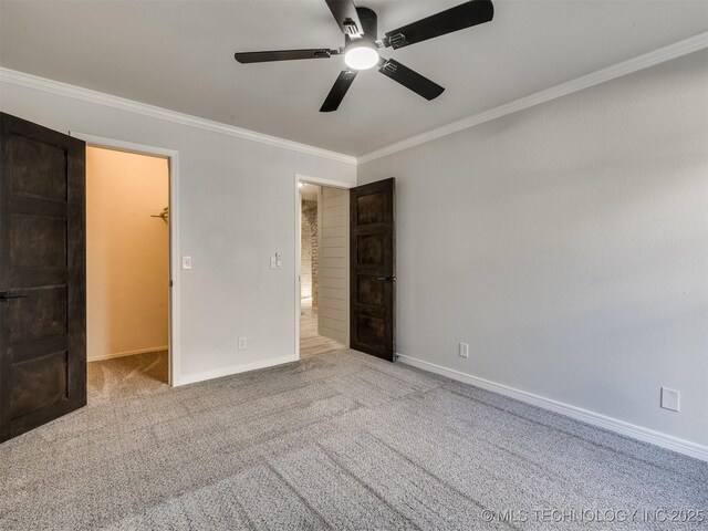 7507 S 92nd E Ave, Tulsa, OK 74133 - unfurnished bedroom with crown molding, a walk in closet, carpet flooring, and ceiling fan
