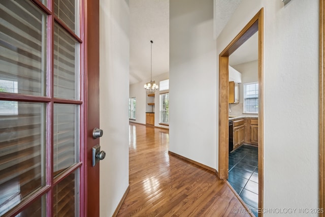 5117 E 89th St, Tulsa, OK 74137 - foyer featuring a chandelier, plenty of natural light, wood finished floors, and a towering ceiling