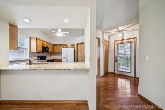 5117 E 89th St, Tulsa, OK 74137 - kitchen with black appliances, vaulted ceiling, ceiling fan, wood finished floors, and light stone counters