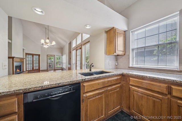 5117 E 89th St, Tulsa, OK 74137 - kitchen featuring dishwasher, vaulted ceiling, light stone counters, brown cabinets, and a chandelier