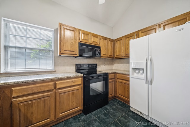 5117 E 89th St, Tulsa, OK 74137 - kitchen with black appliances, vaulted ceiling, decorative backsplash, dark tile patterned floors, and brown cabinetry