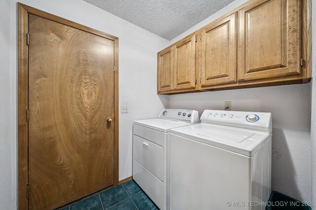 5117 E 89th St, Tulsa, OK 74137 - laundry area with washing machine and clothes dryer, cabinet space, dark tile patterned flooring, and a textured ceiling