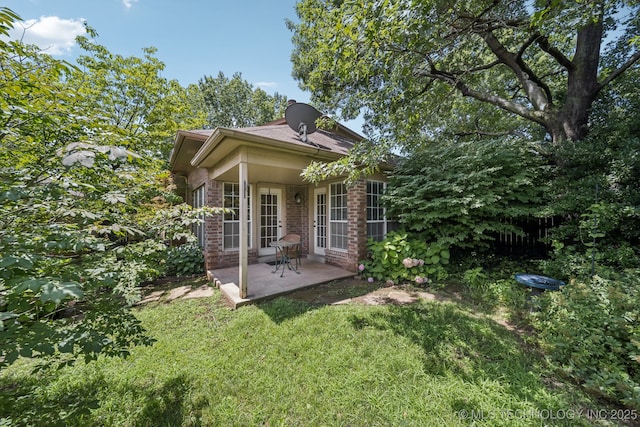 5117 E 89th St, Tulsa, OK 74137 - view of side of home with brick siding and a patio area