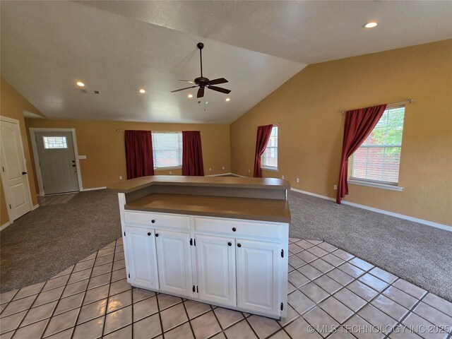 2202 Sycamore Rd, Mcalester, OK 74501 - kitchen with light colored carpet, open floor plan, vaulted ceiling, a ceiling fan, and white cabinets