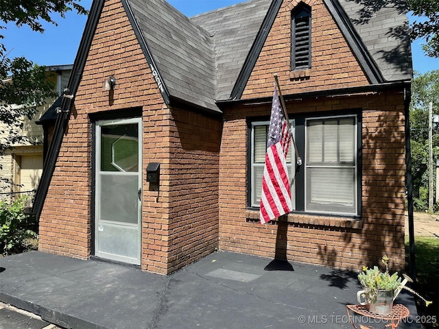 1927 N Cheyenne Ave, Tulsa, OK 74106 - view of front of home featuring a patio area and brick siding