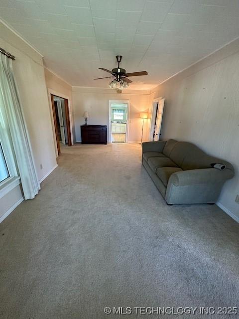 717 N Burns, Holdenville, OK 74848 - carpeted living area featuring crown molding and ceiling fan