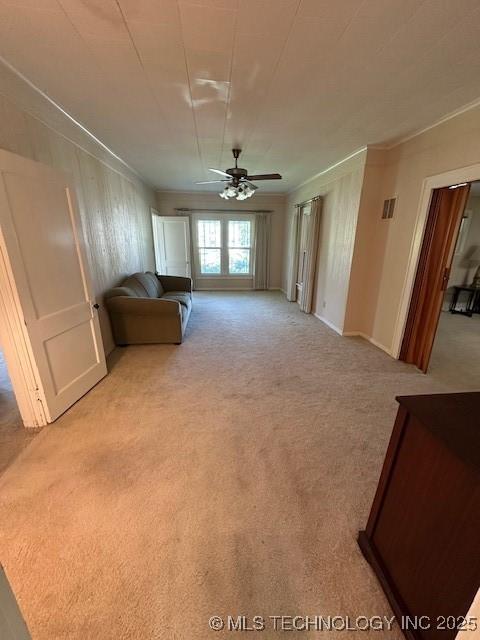717 N Burns, Holdenville, OK 74848 - carpeted living room featuring ceiling fan and crown molding